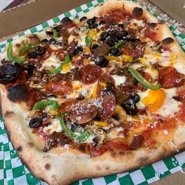 A square L.A. Waterfront Pizza with pepperoni, olives, peppers, mushrooms, and sausage in a box.